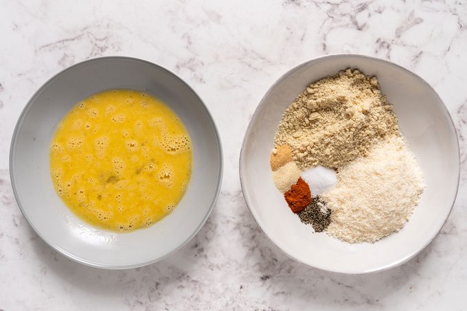 Beaten egg and mix of spices in separate bowls