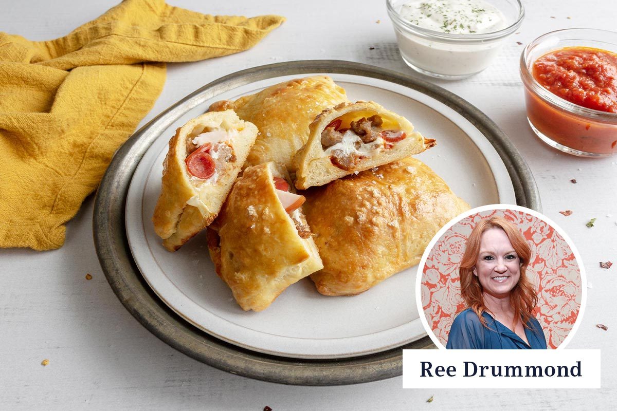 Pioneer woman pizza pockets on a plate with a yellow napkin and dipping sauces to the side