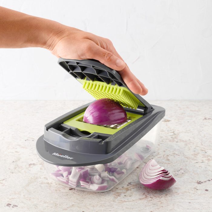 using the Mueller Vegetable Chopper to chop an onion
