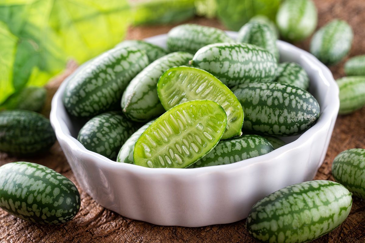 Fresh Harvested Cucamelons in a bowl on a rustic wooden table