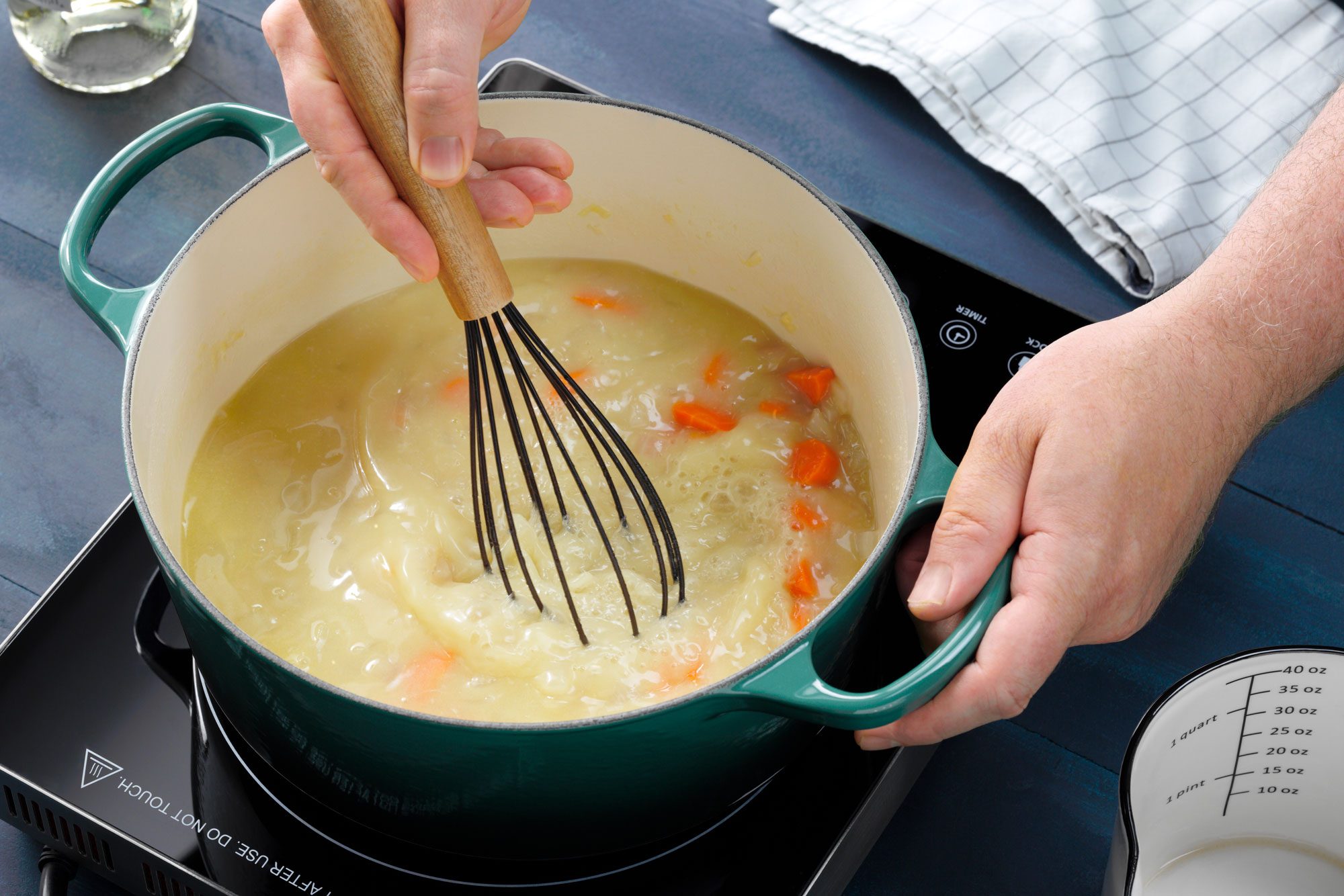whisking the broth for creamy tortellini soup