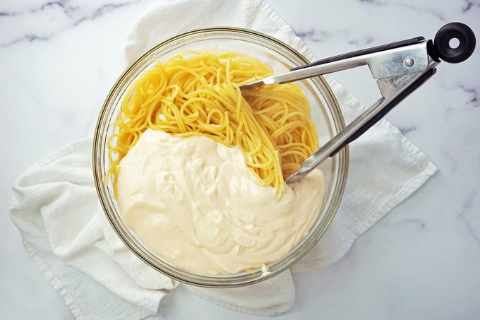 cooked pasta and Alfredo sauce in a bowl