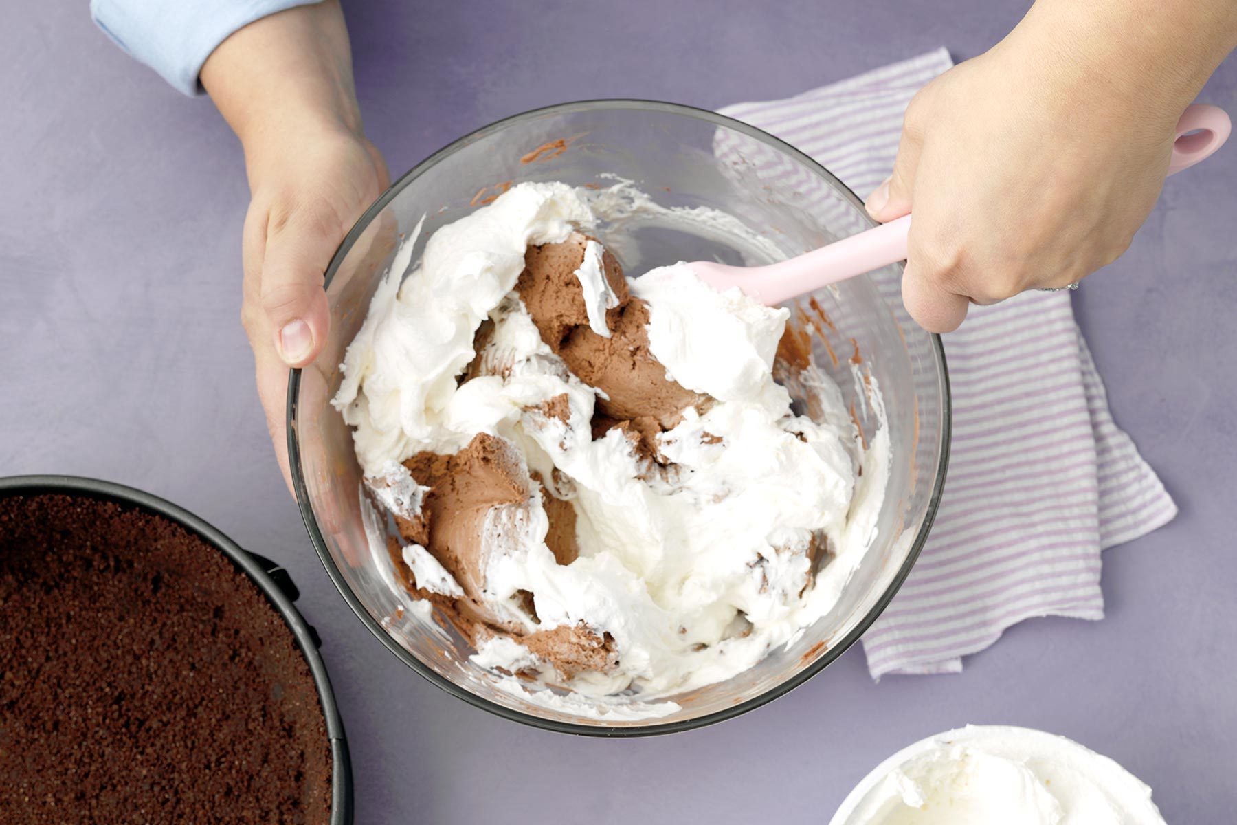 A Person Mixing a Chocolate Cheesecake Batter