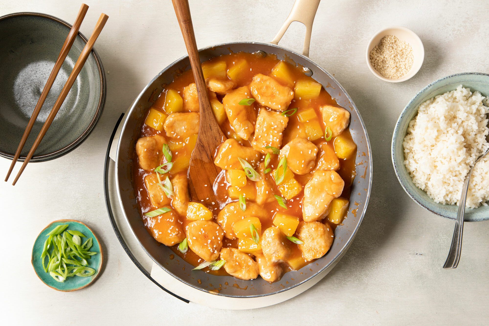 Sweet And Sour Chicken with rice bowl and chopsticks