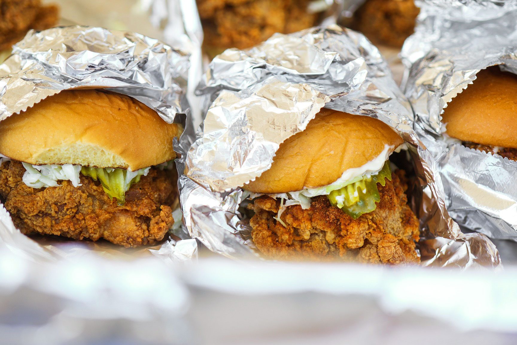 crispy fried chicken sandwiches in foil