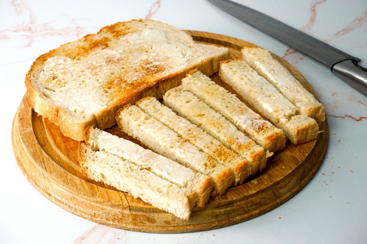 Cutting Toast For Dippy Eggs Lauren Habermehl For Taste Of Home 