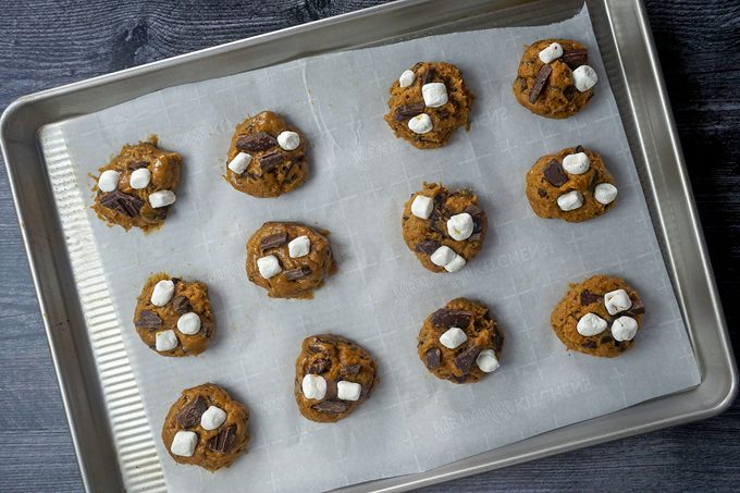 divided cookie dough balls on parchment paper
