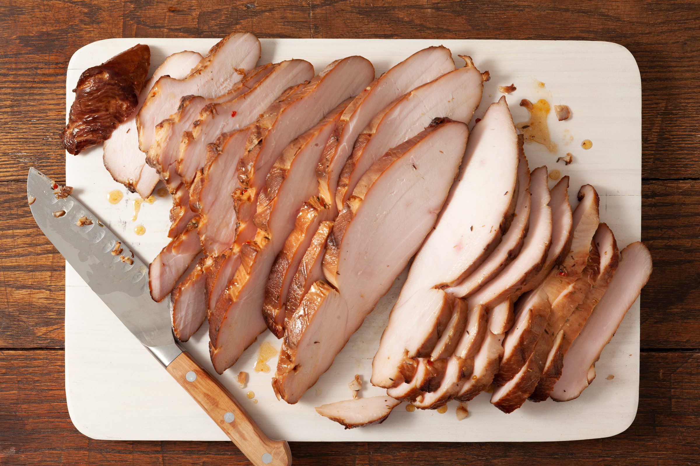 Brined Grilled Turkey Breast sliced on a cutting board