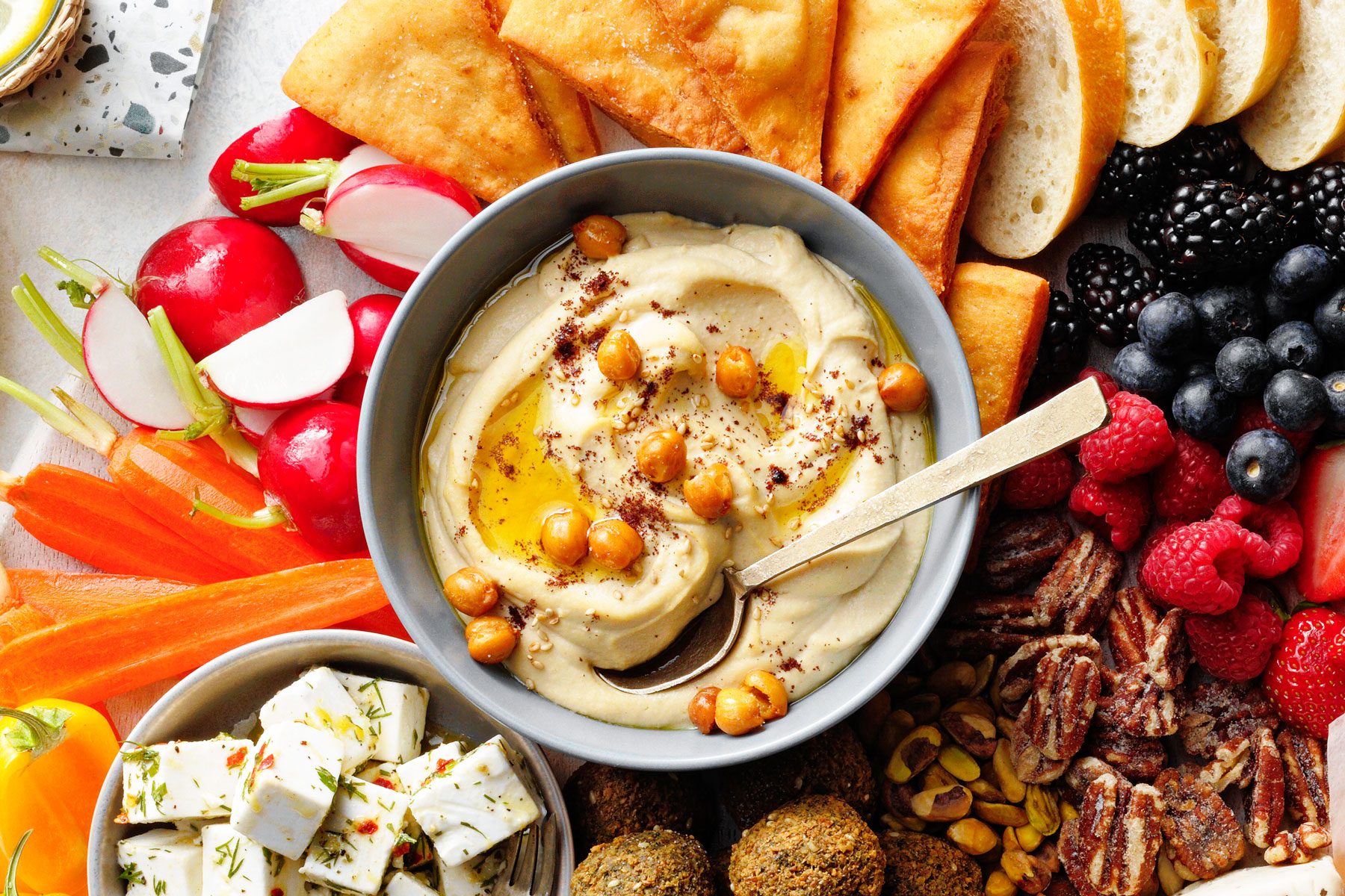 Fresh Hummus in a small bowl other other foods