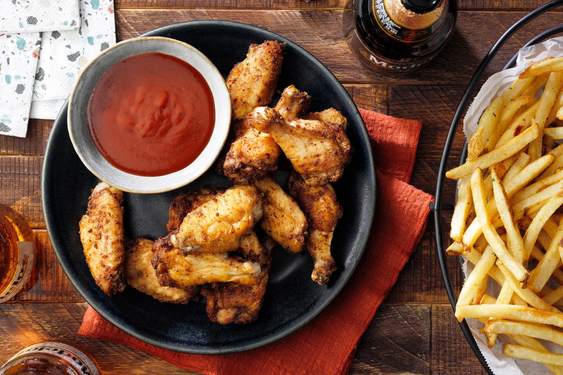 Air Fryer Chicken Wings served in a plate with sauce and french fries
