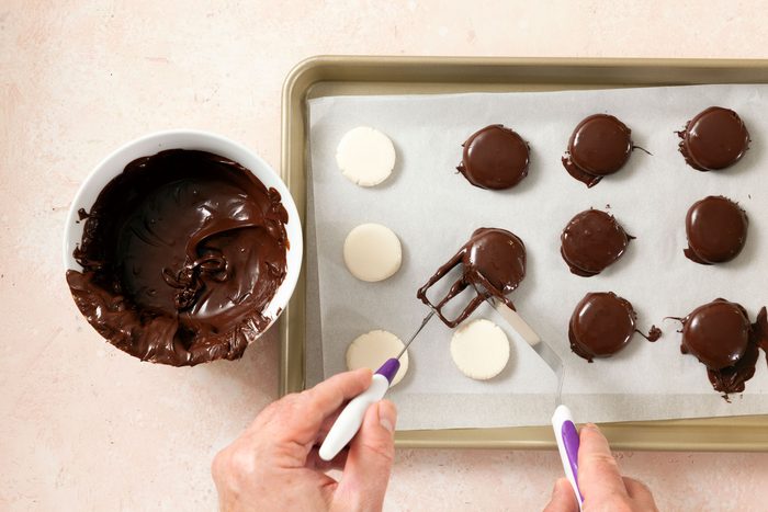 Dip the peppermint patties in chocolate with fork