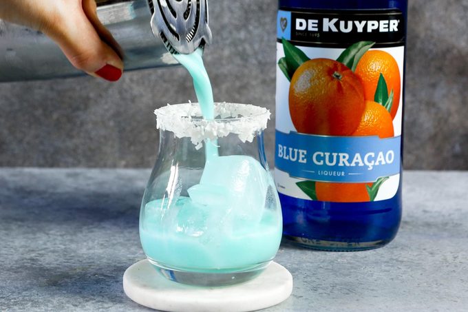 pouring Jack Frost Cocktail into a glass