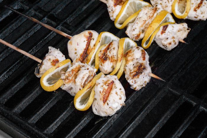 chicken pieces and the lemon slices on on the grill