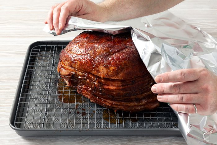 Tent the ham with foil