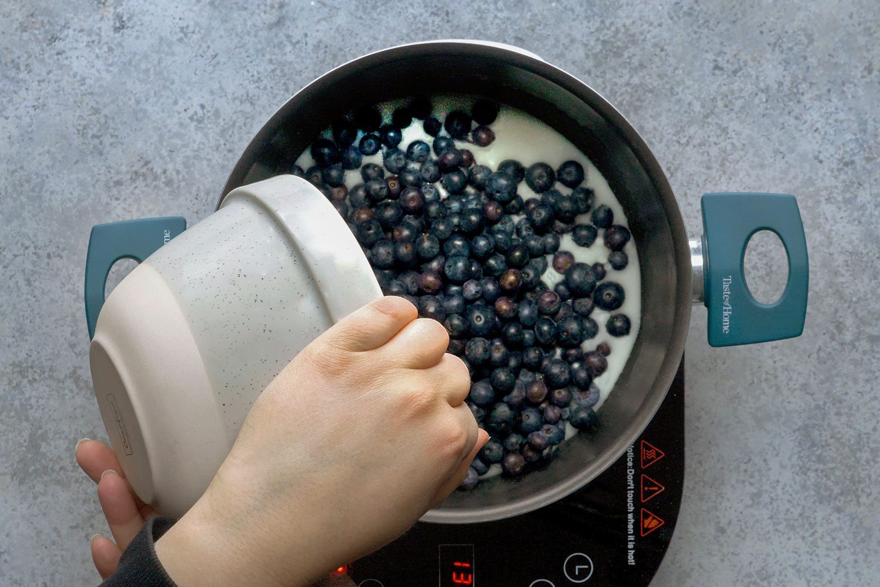 Adding blueberries in sauce pan