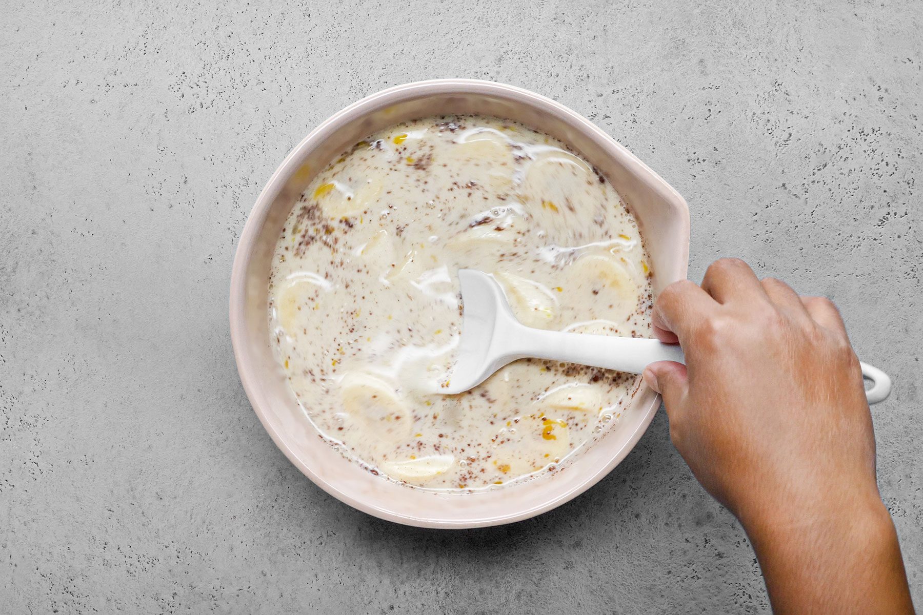 Stirring Bananas in a large bowl