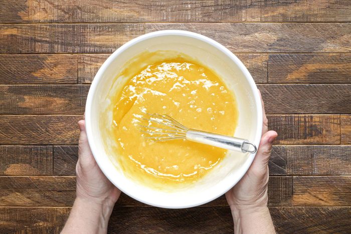 Whisk together the eggs, bananas, sugar and oil in other bowl