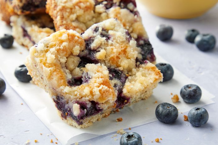 A close up of Blueberry Kuchen on a marble countertop with blueberries