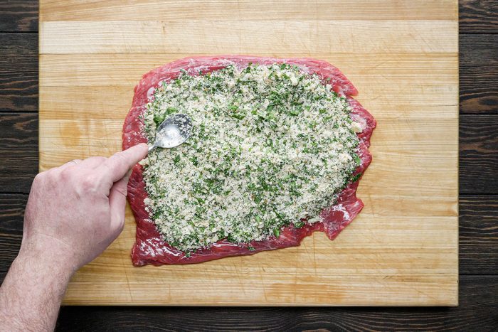 Spoon the stuffing over the beef and press down gently