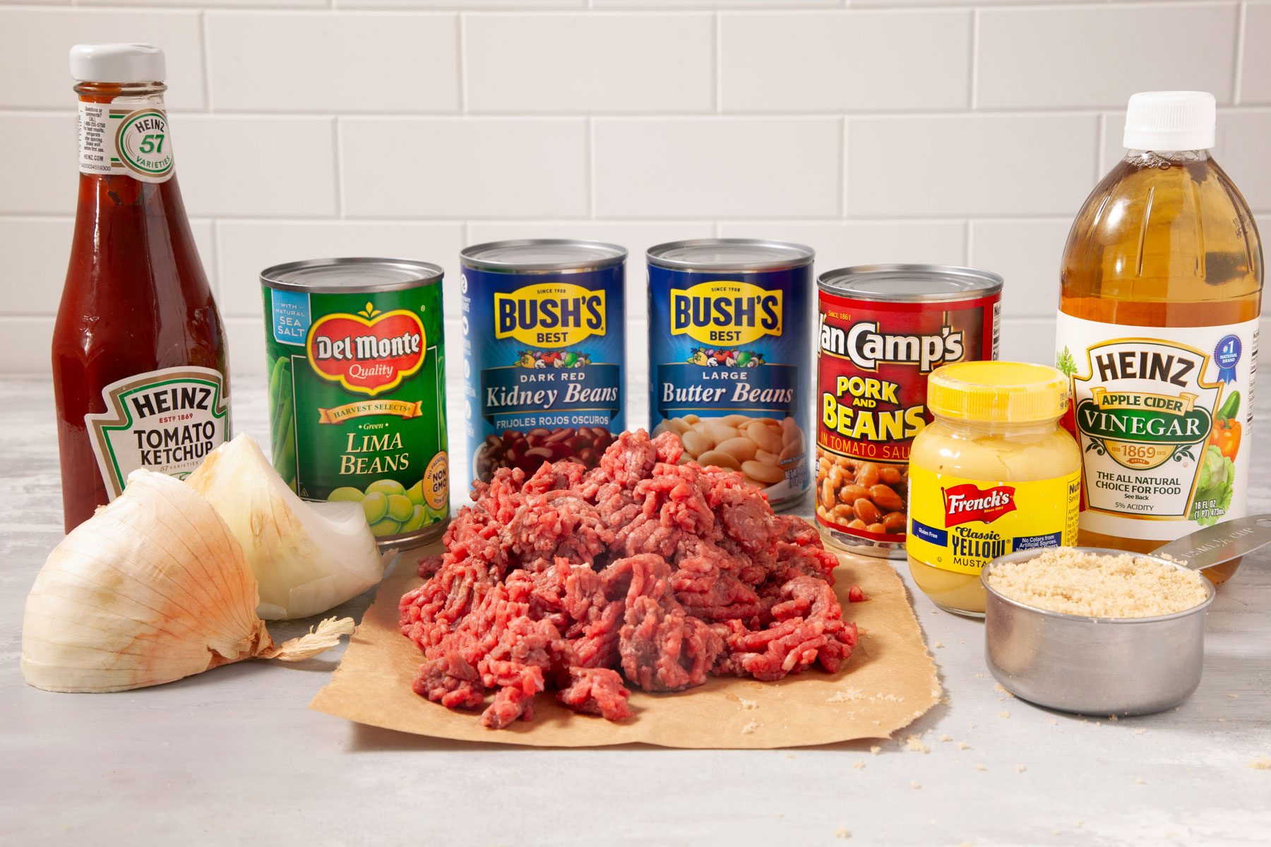 Beef onions bean and other ingredients placed on a marble surface