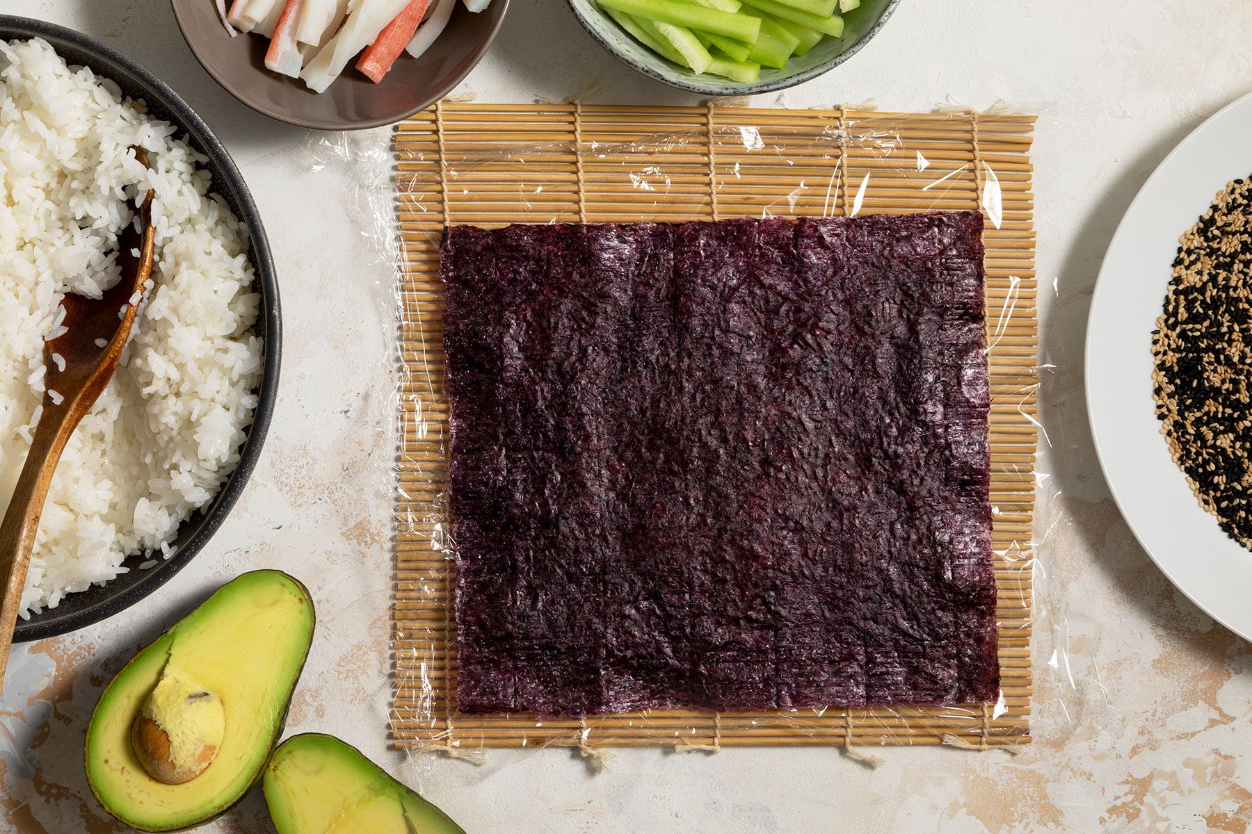 Nori sheet placed on top of rice on sushi mat