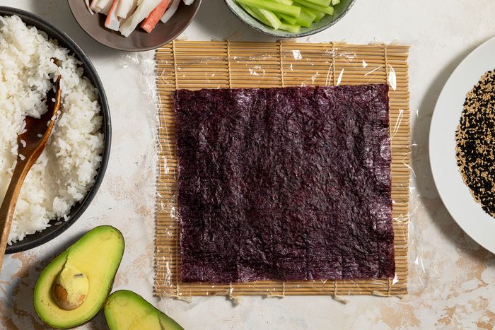 Nori sheet placed on top of rice on sushi mat