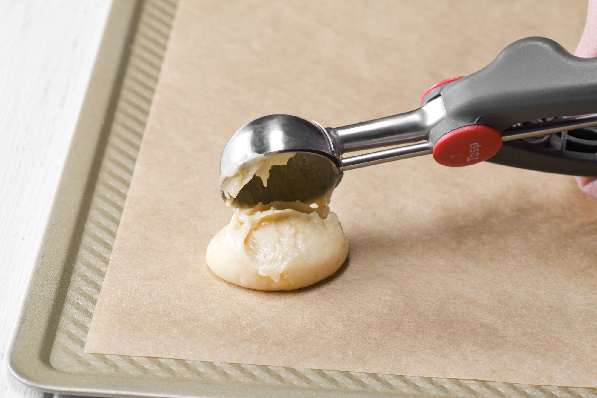 Placing teaspoonful dough on parchment paper