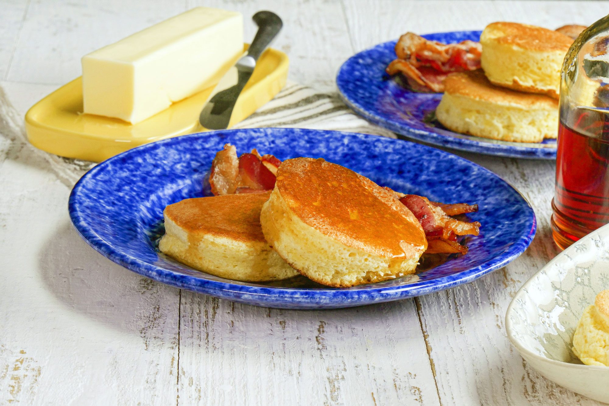 Japanese Pancakes Served On A Fancy Blue Plate On White Painted Wooden Surface