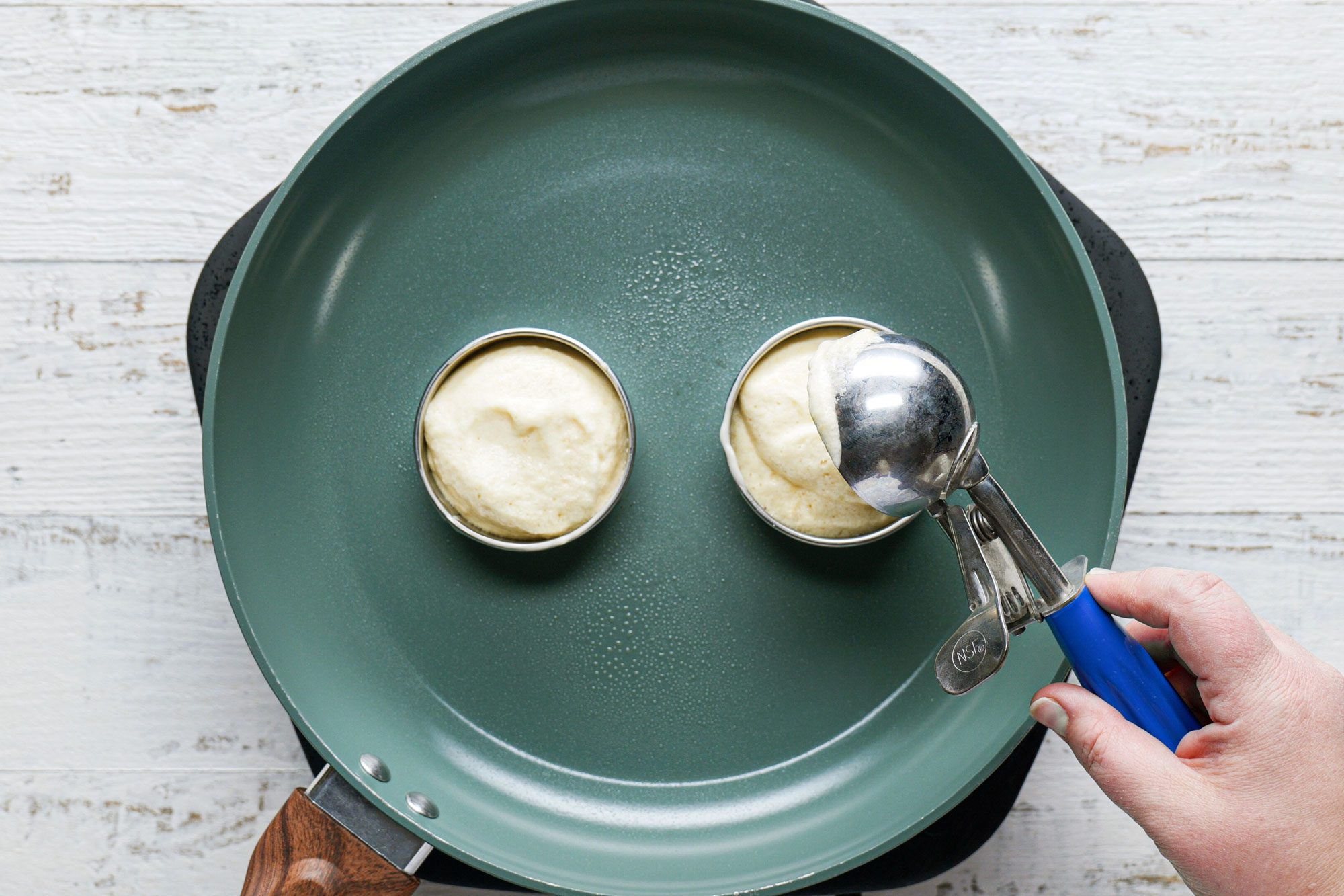 Cooking Japanese Pancakes In A Pan, White Painted Wooden Surface
