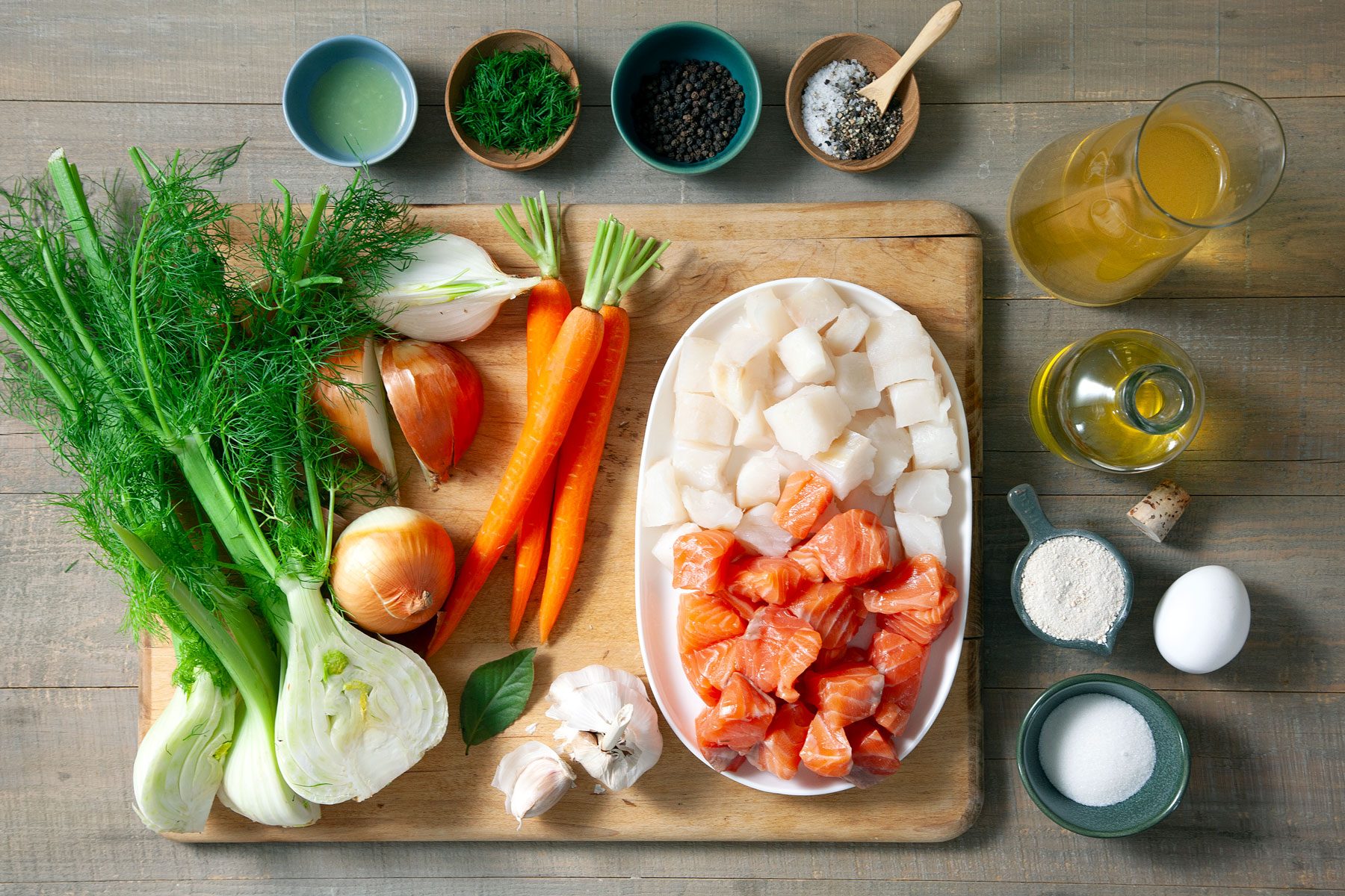 Vegetables eggs meat oil and other ingredients placed on a wooden table