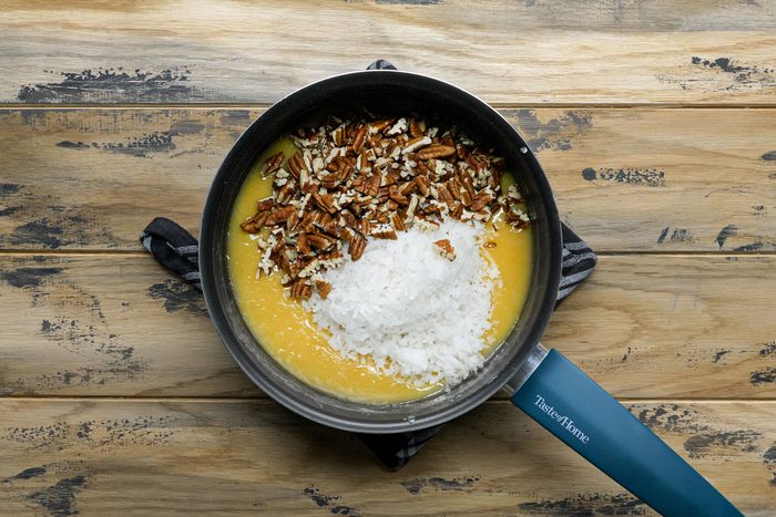 Coconut pecans added in eggs and milf mixture in a sauce pan