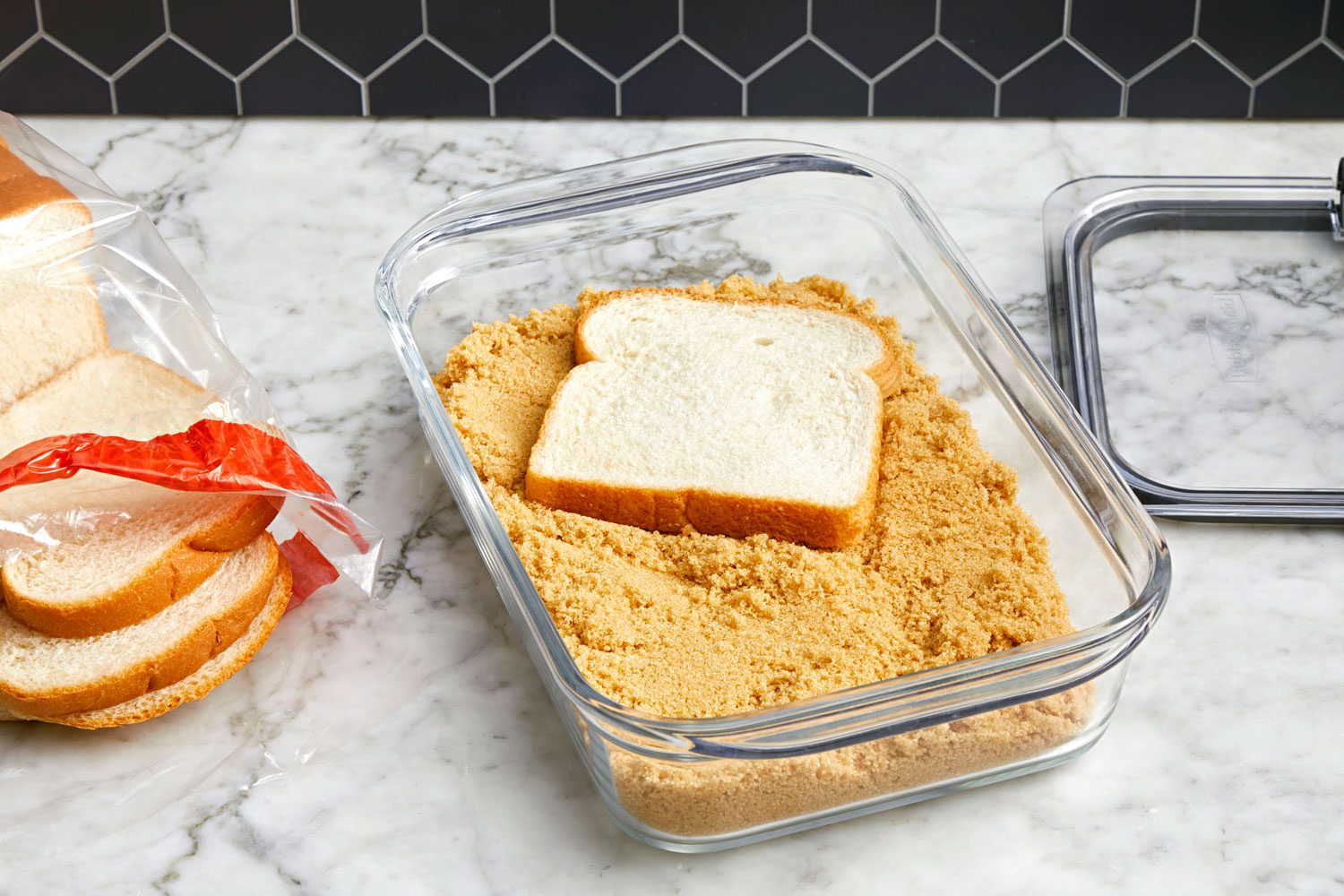 Container of brown sugar with a slice of white bread