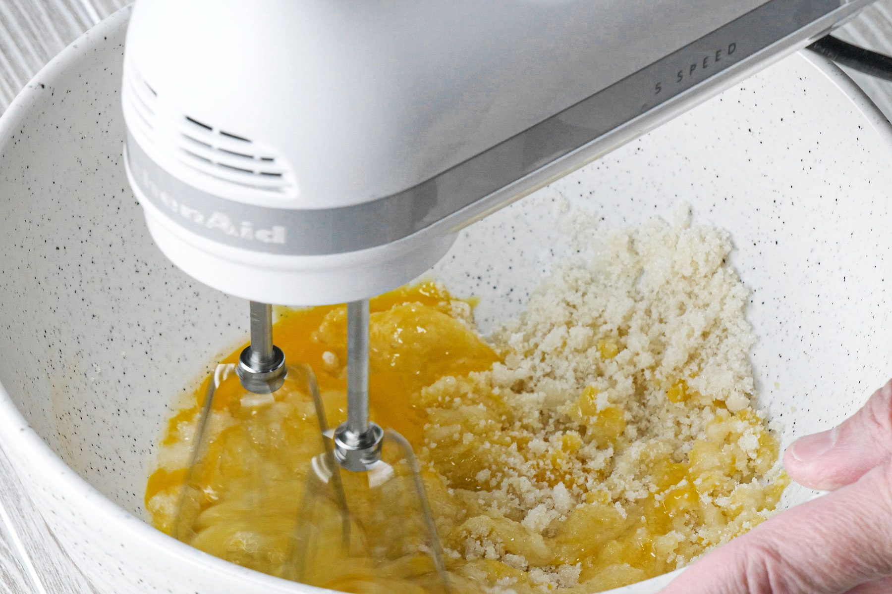 Beating eggs in large bowl with hand mixer