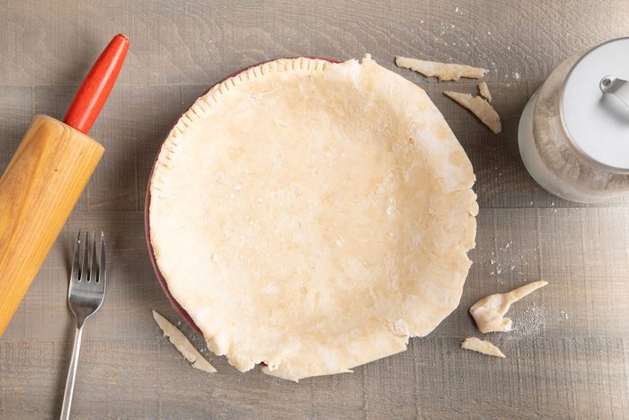 Trimming the crust in a plate on a wooden table