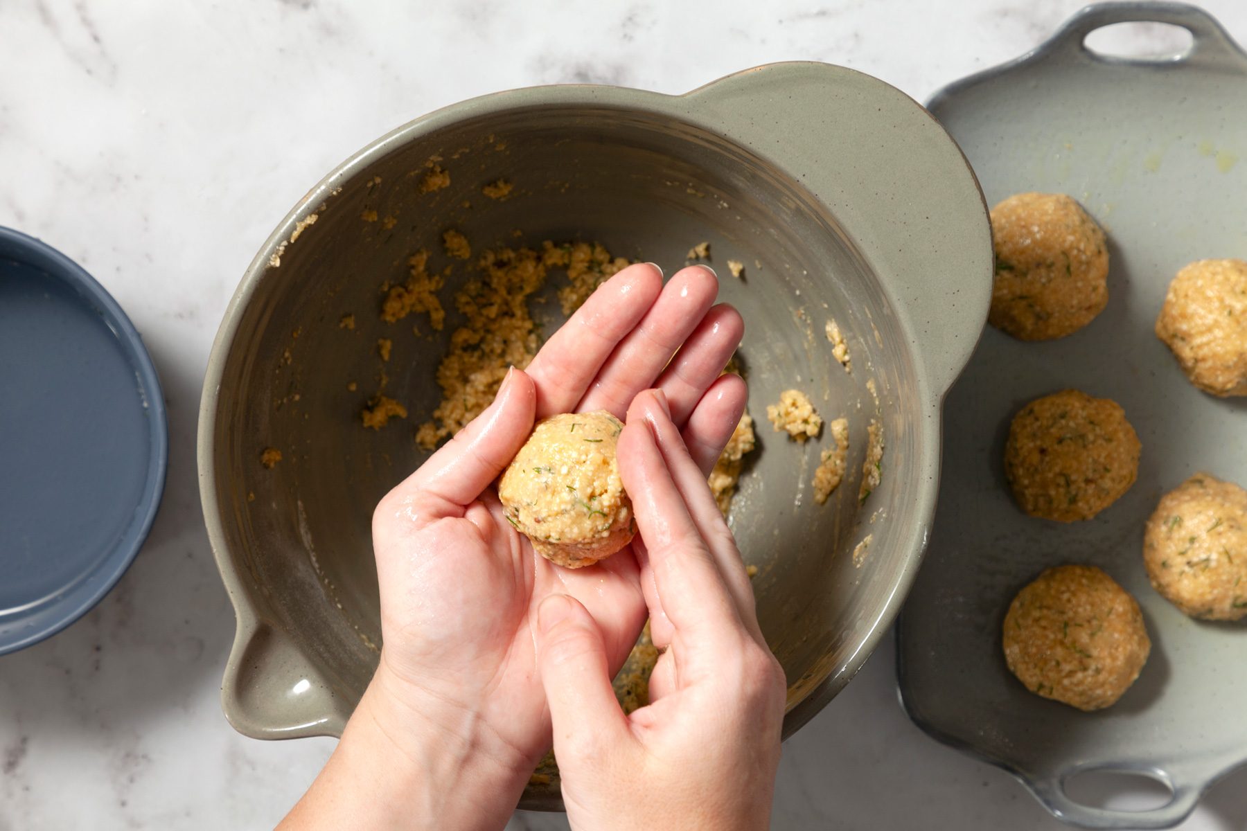 A person shaping a matzo ball in their hands