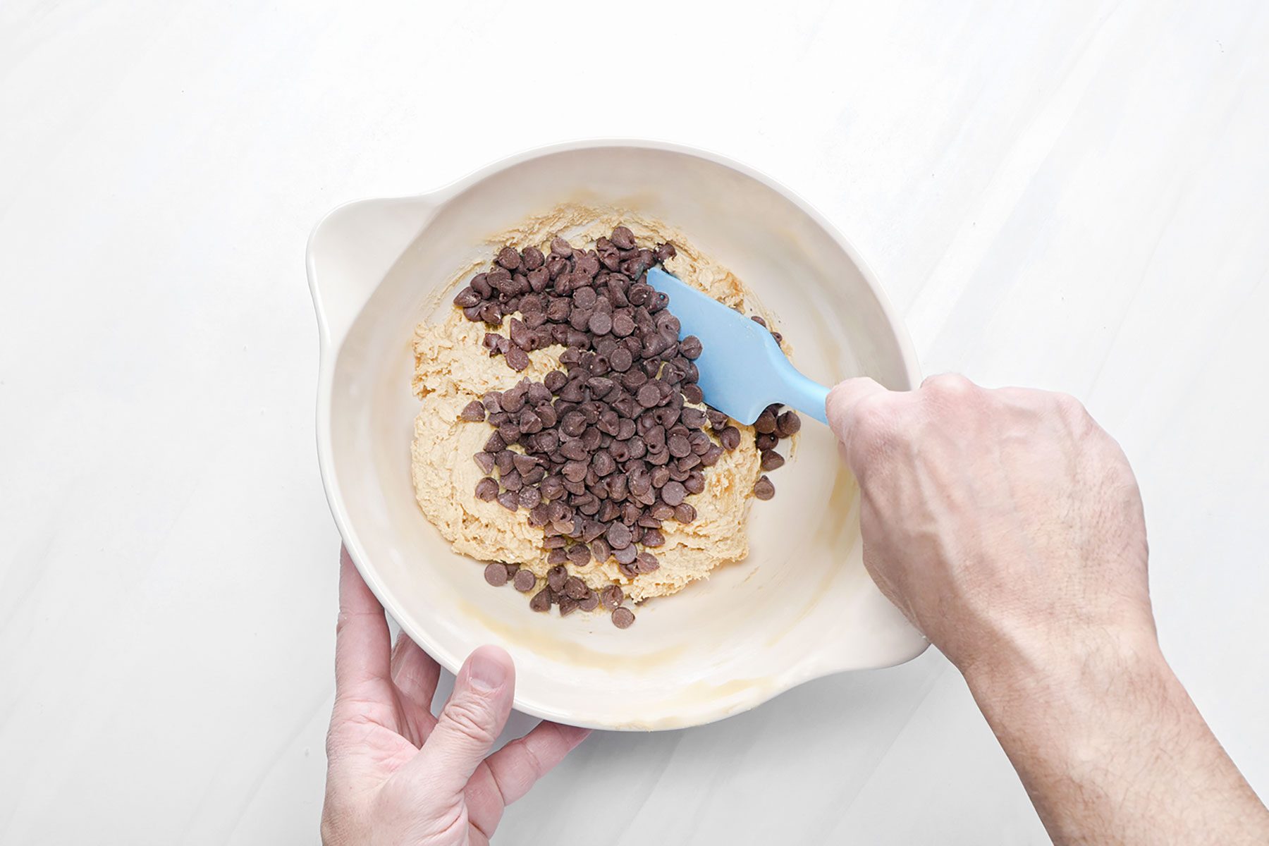 Folding chocolate chips in cookie dough mixture