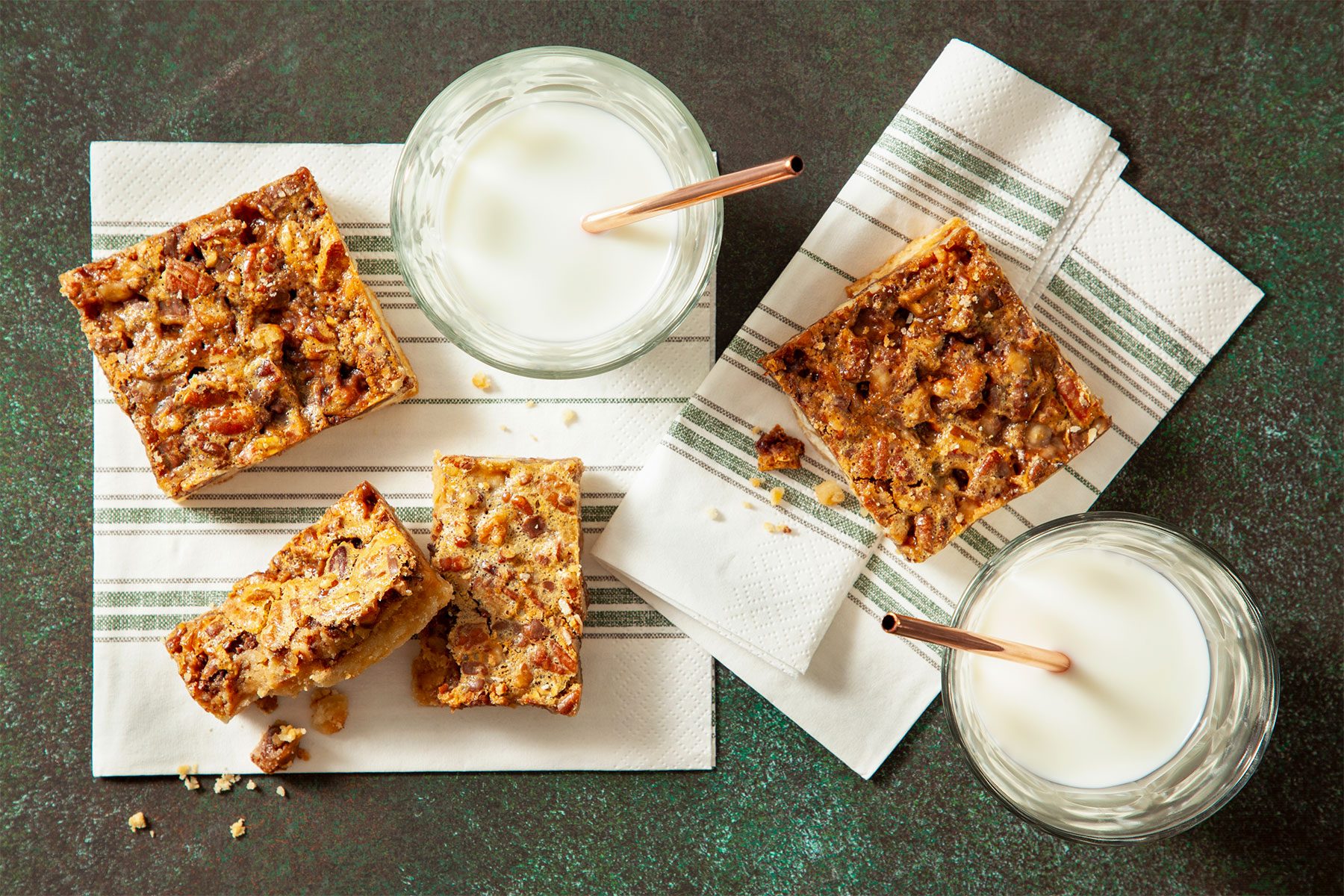 Top Shot of Pecan Pie Bars with glasses of milk