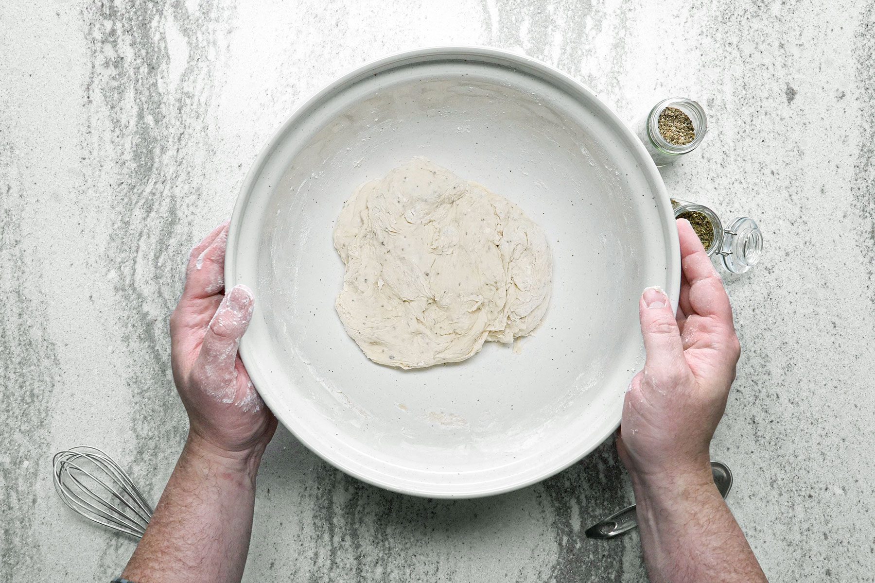 Pizza dough resting in large bowl