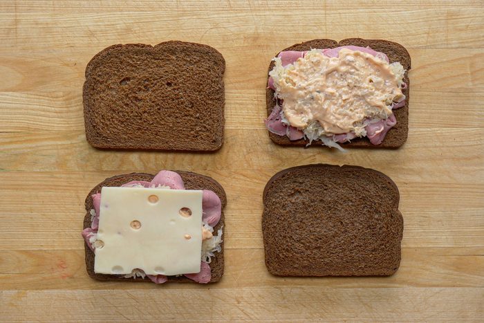 Slice of cheese sauce beef and sauerkraut layered on bread