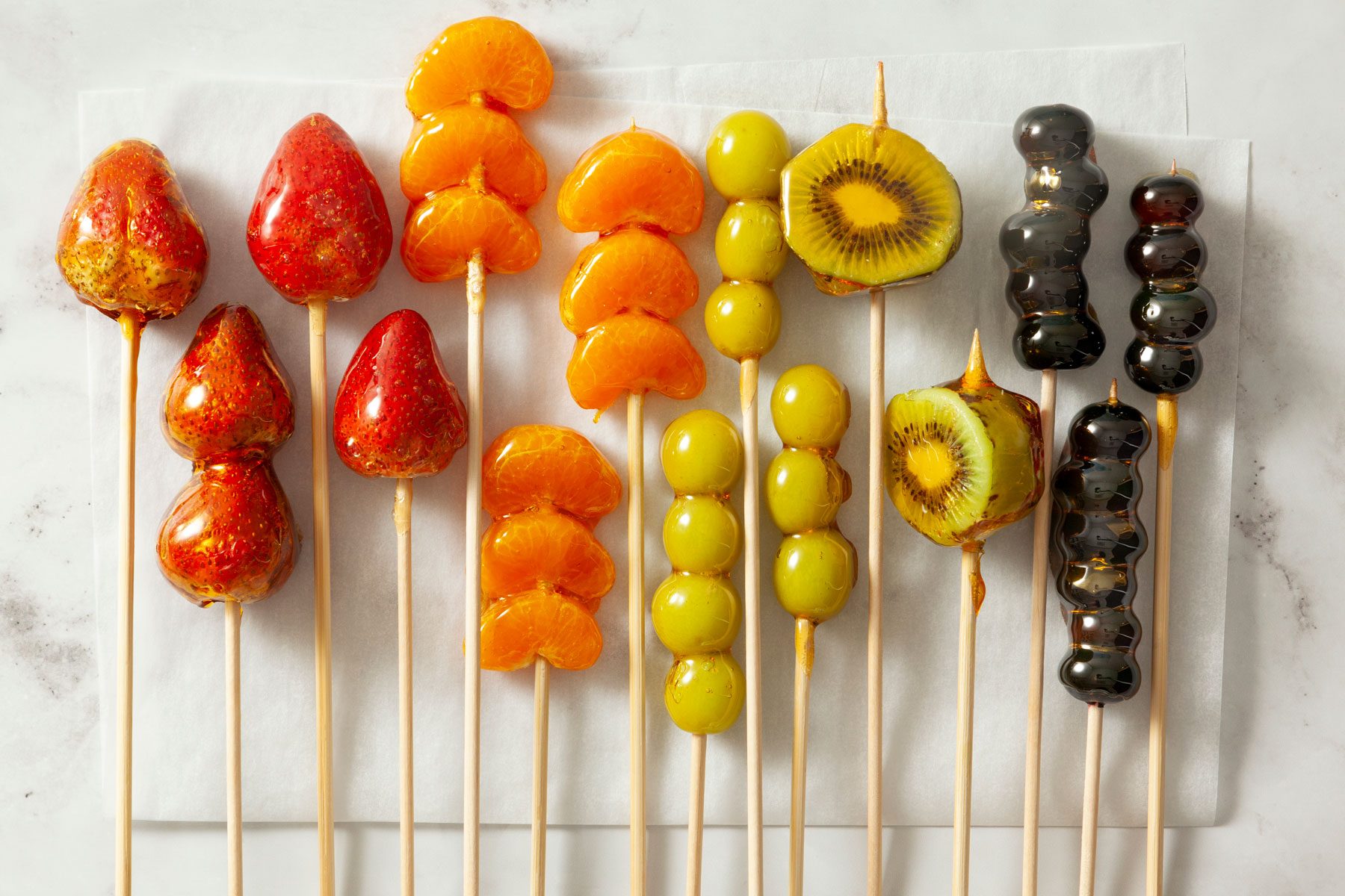 Strawberries with other fruits arranged on a kitchen countertop 