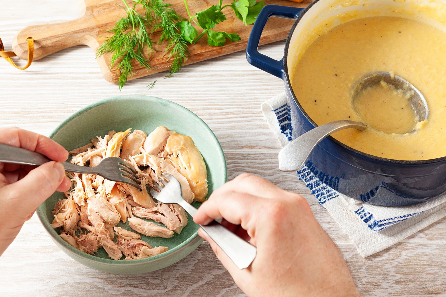 Shredding the chicken with forks