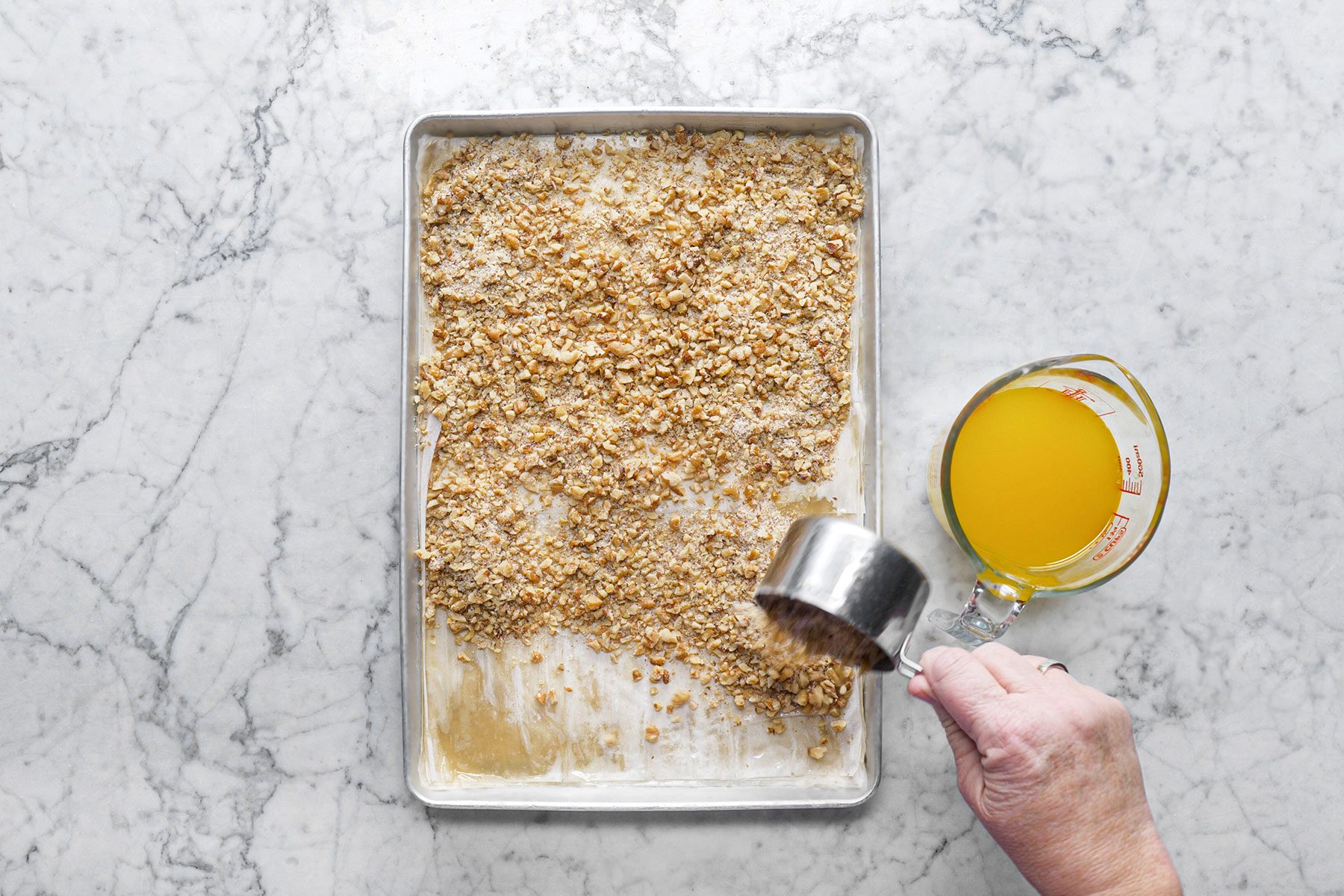 Spreading walnuts on sheet 