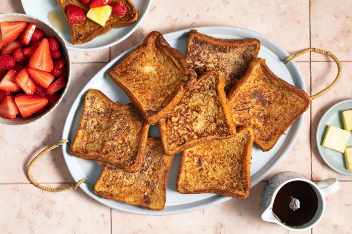 Cinnamon French in a plate served with coffee and straberries
