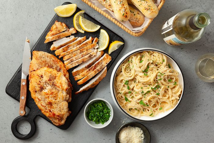 a platter of chicken and a bowl of pasta for Lemon Chicken Pasta
