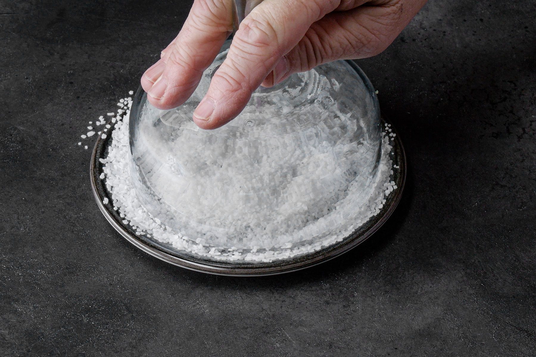 Dipping the rim of the glass in salt