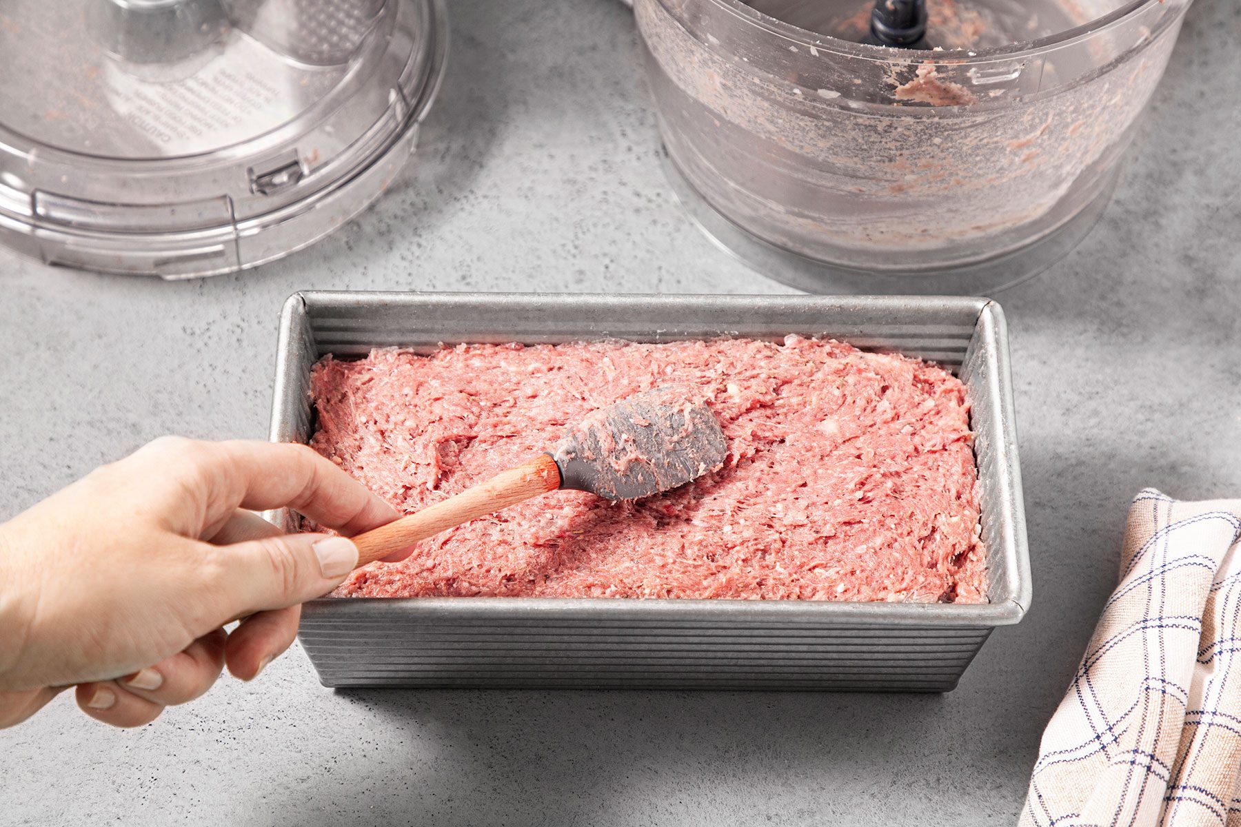 Pressing meat mixture in baking dish