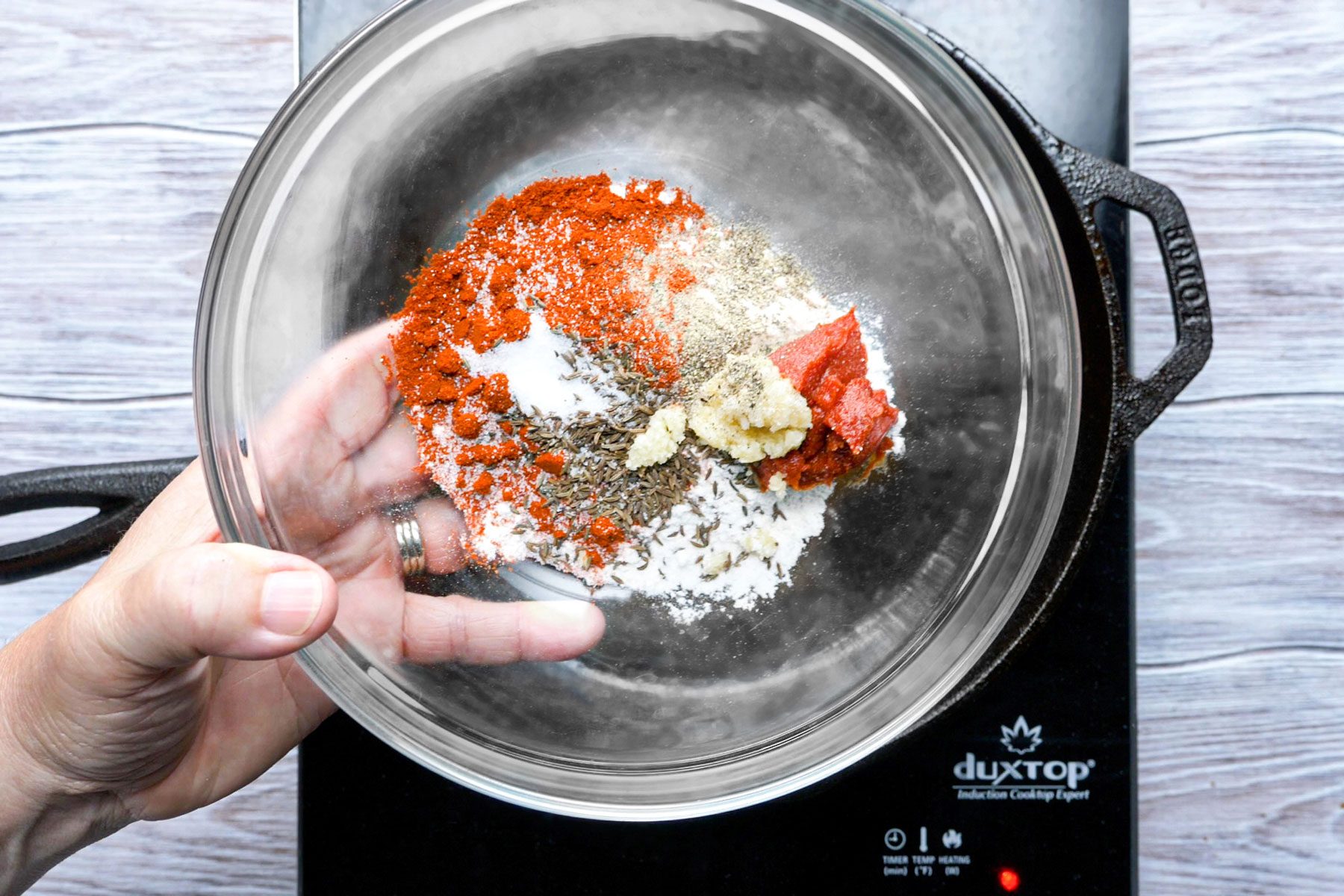 Flour, paprika, tomato paste combined in a large bowl