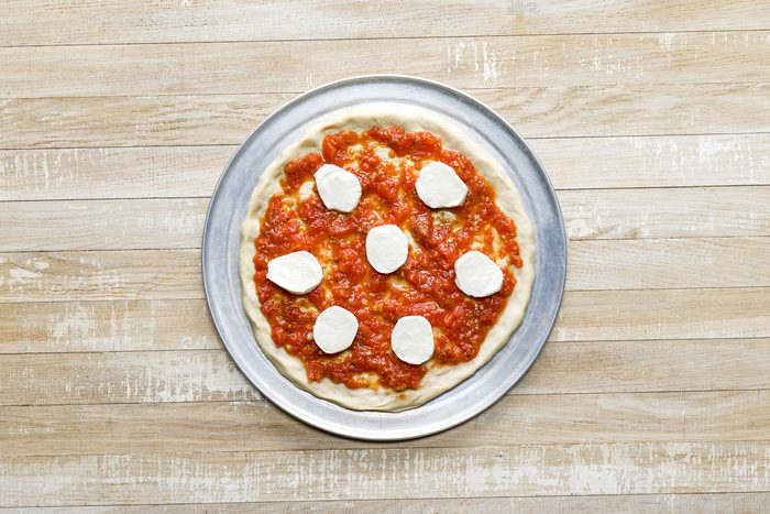 A margherita pizza on a pan