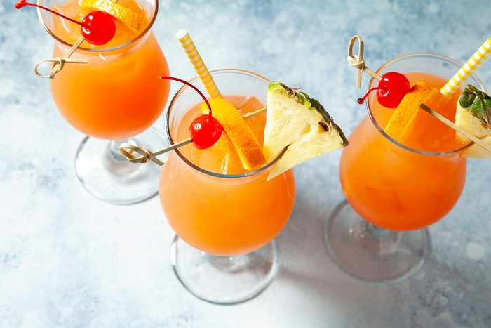 high angle shot of sweet rum punch garnished with fruits