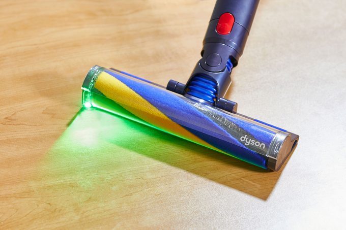 A green LED light on the head of Dyson vacuum